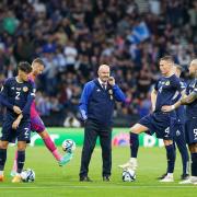 Scotland manager Steve Clarke, centre, and his players at Hampden tonight during a rain delay