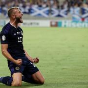 Scotland centre half Ryan Porteous drops to his knees and celebrates his first international goal in the Euro 2024 qualifier against Cyprus in Larnaca tonight