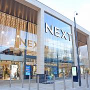 Retailer Next defies expectations and hints at falling prices