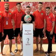 Craig poses with his painted football and the Moroccan World Cup squad