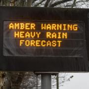 An amber weather warning sign on the motorway in Dumfries, Scotland