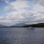 A pleasure cruise sails into the southern end of Loch Lomond