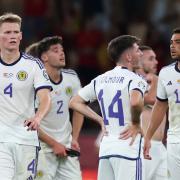 Scott McTominay, left, and his Scotland team mates after the 2-0 defeat to Spain in Seville last night
