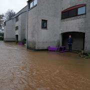 A man views flood water in Breching during the storm