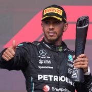 Mercedes driver Lewis Hamilton, of Britain, celebrates on the podium after the Formula One U.S. Grand Prix auto race at Circuit of the Americas, Sunday, Oct. 22, 2023, in Austin, Texas. (AP Photo/Darron Cummings)