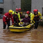 Members of the emergency services help local residents to safety in Brechin