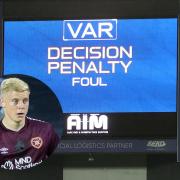 The giant screen at Ibrox on Sunday shows Rangers have won a penalty, main picture, and Alex Cochrane of Hearts, inset
