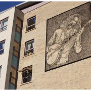 Andy Scott's distinctive mural of the Big Yin, complete with banjo
