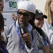 Nile Rodgers, musician and producer, center left, speaks during a demonstration at the COP28 U.N. Climate Summit, Wednesday, Dec. 6, 2023, in Dubai, United Arab Emirates. (AP Photo/Peter Dejong)