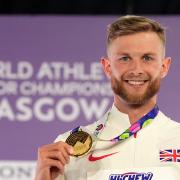 Josh Kerr celebrates gold on the podium for the Men's 300 metres during day two of the World Indoor Athletics Championships