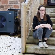 Nina Murray pictured at home in the Southside of Glasgow. Nina has had her home retrofitted with an air source heat pump (pictured at left) and extra insulation.    ..  Photograph by Colin Mearns.28th March 2024.For Herald on Sunday, see story by Vicky