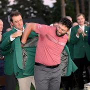 Jon Rahm slips into the green jacket after winning the 2023 Masters