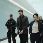 Dr Matthew Nolan (Richard Armitage, centre) and DC Li (Jing Lusi) head to the gate