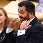 Scottish First Minister Humza Yousaf reacts as he answers questions during First Minister's Questions at Scottish Parliament at the Scottish Parliament Building on April 25, 2024