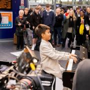 Crowds gather at Manchester Piccadilly to hear Ethan 9, on The Piano