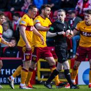 Referee Craig Napier shows Motherwell's Jack Vale a red card