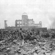 An Allied correspondent stands in a sea of rubble in Hiroshima a month after the bomb was dropped in 1945. How big is the risk of such scenes being repeated?