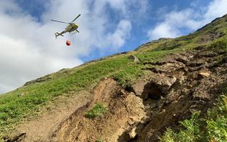 Photo issued by BEAR Scotland of a helicopter that was being used to clear a 100-tonne boulder from above the A83 Rest and Be Thankful in August, 2020 as efforts to clear a large landslip continued,