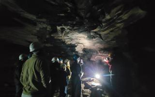 Members of the Save Wemyss Ancient Caves Society (S.W.A.C.S.) and visitors within the caves