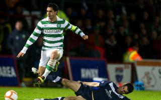 Celtic midfielder Beram Kayal jumps out of a slide tackle in a League Cup game against Ross County in 2011
