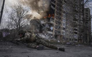 A Ukrainian soldier takes cover