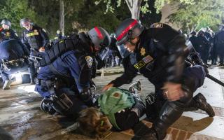 Police arrest a Pro-Palestinian demonstrator as the people protest at UCLA, in Los Angeles, California. (Photo by Grace Yoon/Anadolu via Getty Images).