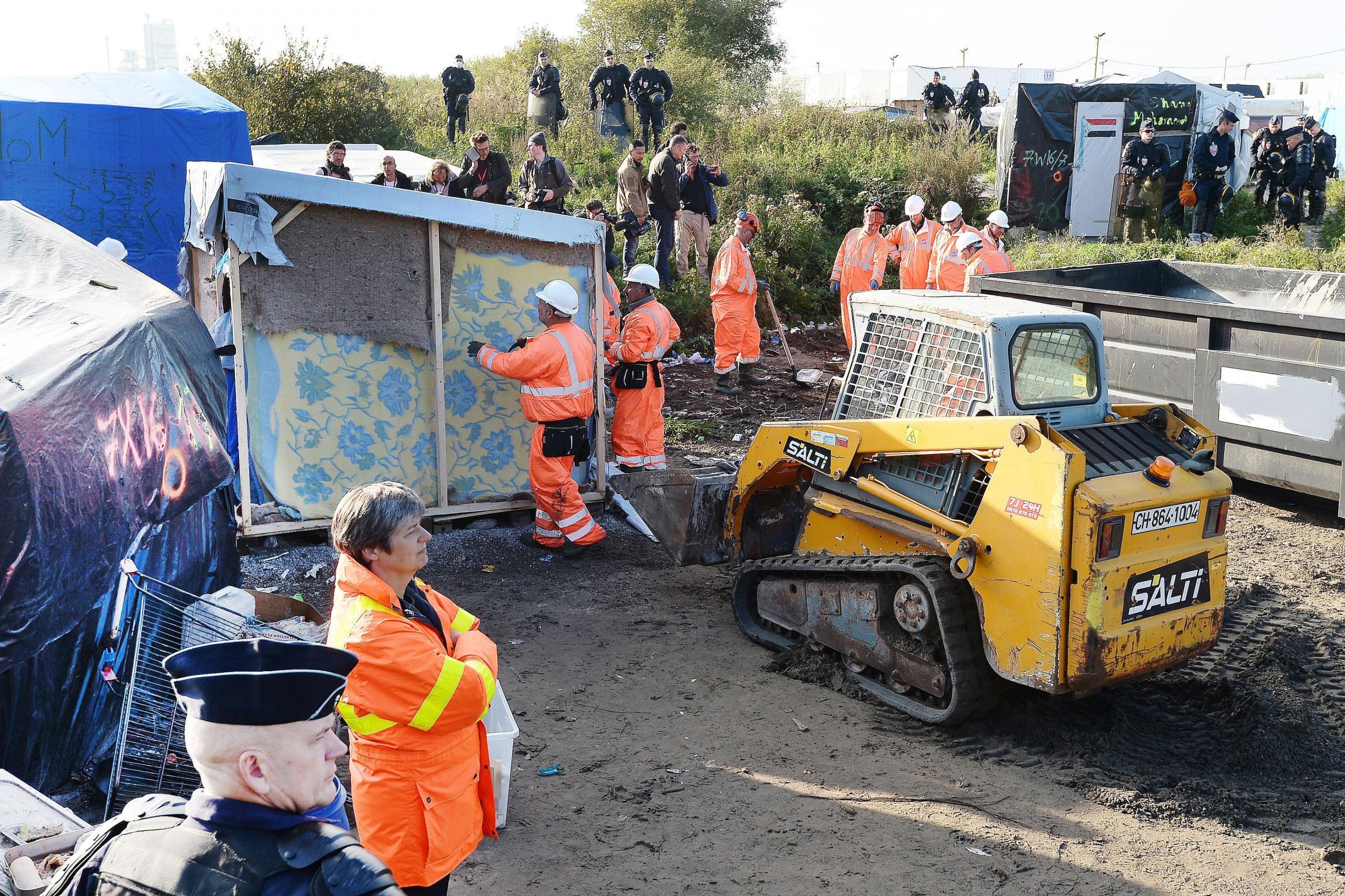 Bulldozers move in at Calais 'Jungle' camp as migrants leave by bus