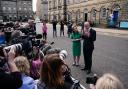 First Minister John Swinney and Deputy First Minister Kate Forbes speaking to reporters outside Bute House