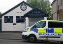 A police vehicle sits outside of A. Milne funeral directors in Balornock, Glasgow.