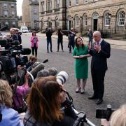 First Minister John Swinney and Deputy First Minister Kate Forbes speaking to reporters outside Bute House