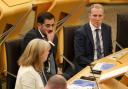 First Minster Humza Yousaf listens as his deputy Shona Robison delivers the Scottish Government's budget plans