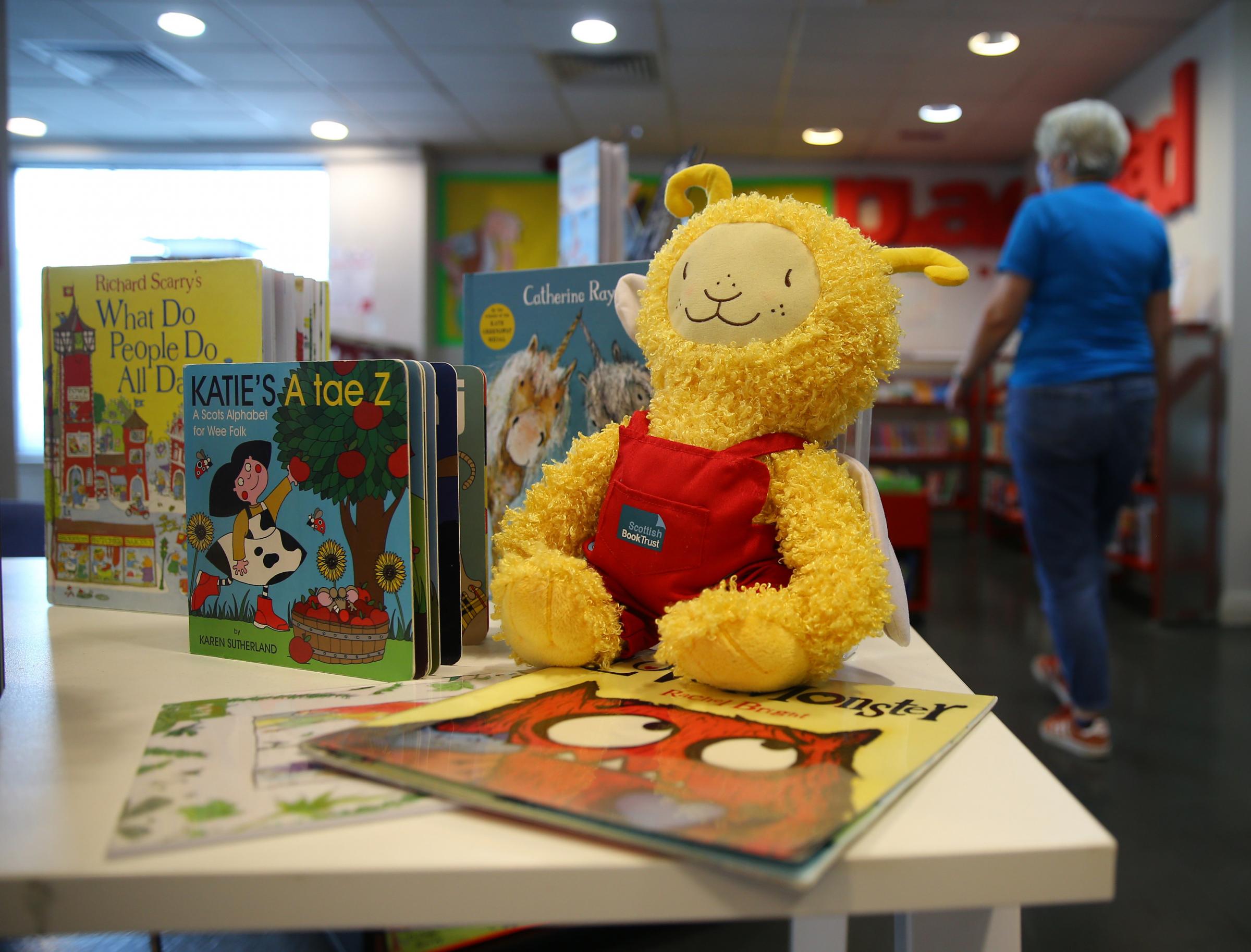 Bookbug figure among books pictured at Gorbals library, Glasgow. Photograph by Colin Mearns.
