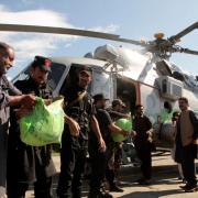 Food for flood victims is loaded on to a helicopter