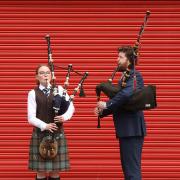Piper Emma Hill and piper, composer and teacher John Mulhearn at the launch of Piping Live! and World Pipe Band Championships 2024 in the Barras