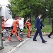 Rescue workers take Slovak Prime Minister Robert Fico, who was shot and injured, to a hospital in the town of Banska Bystrica