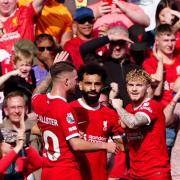 Liverpool’s Mohamed Salah (centre) is congratulated by his team mates after scoring the first goal of the game during the Premier League match at Anfield, Liverpool. Picture date: Sunday May 5, 2024.