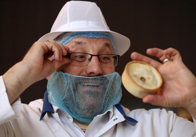 Jim McCormack holds a Scotch pie during judging at the 2020 World Scotch Pie Championship