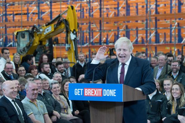 The audience laugh as Prime Minister Boris Johnson speaks during a visit to the JCB cab manufacturing centre in Uttoxeter, while on the General Election campaign trail in 2019