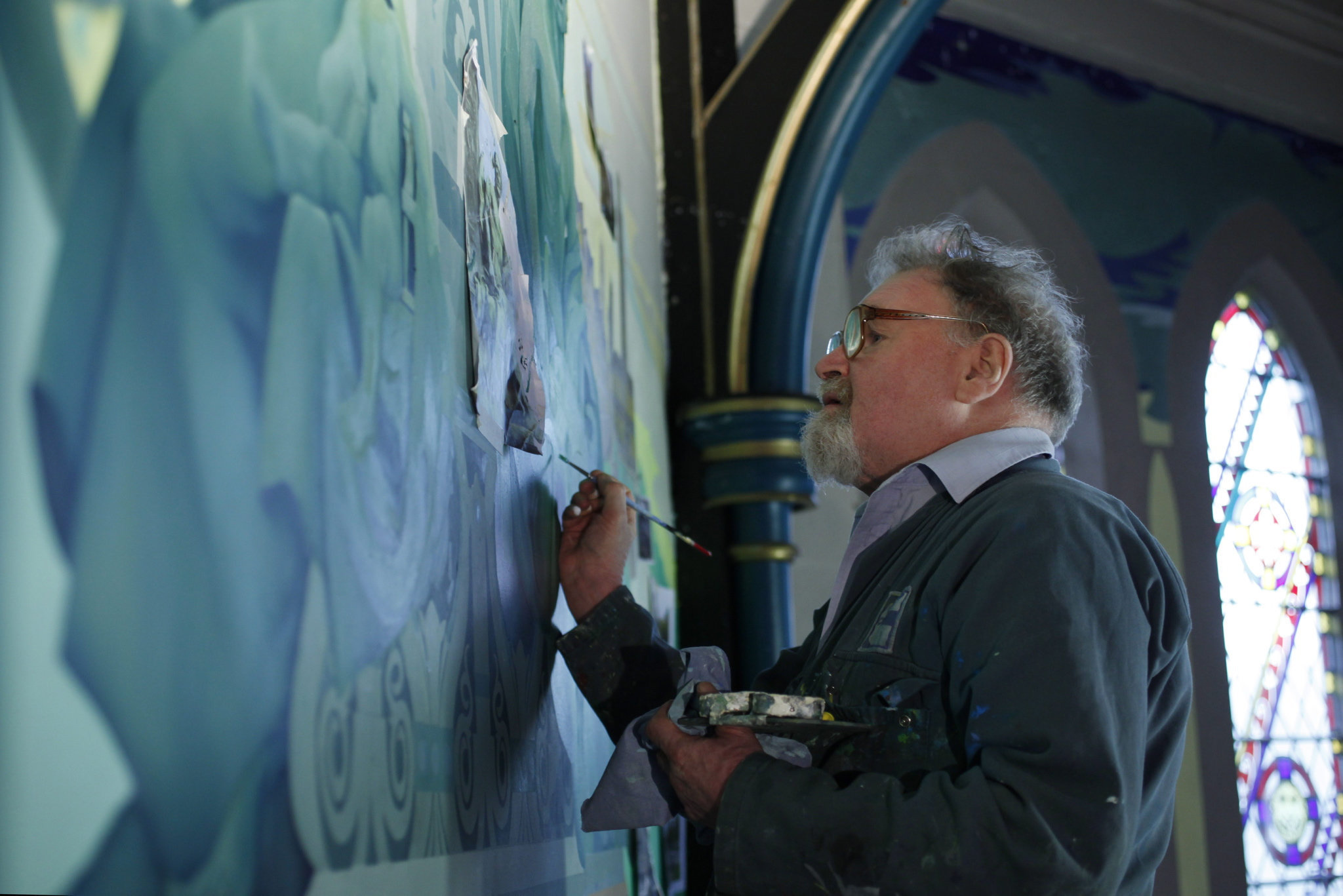 Artist Alasdair Gray, pictured at work on his mural Peace and War, had a long-standing connection with the Peoples Palace. Photograph by Colin Mearns.