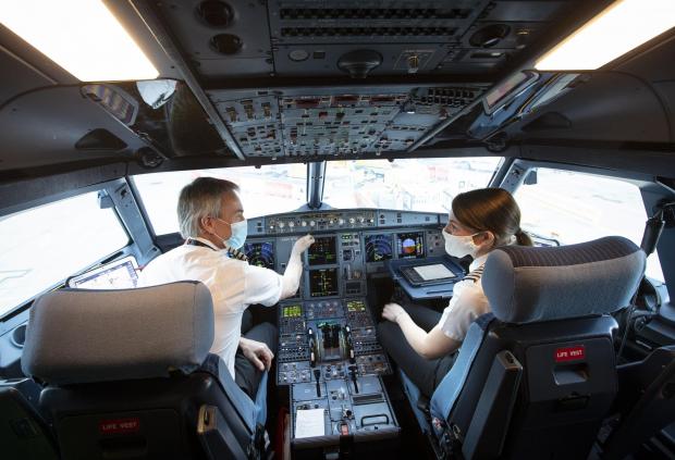HeraldScotland: Director of Flight Operations Captain David Morgan and Captain Kate McWilliams in the cockpit of easyJet flight EZY883. Credit: PA