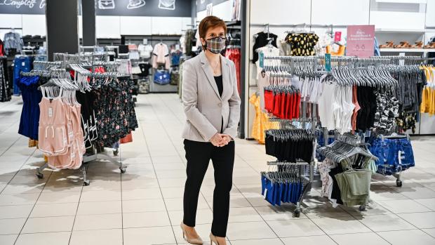HeraldScotland: First Minister Nicola Sturgeon, wearing a Tartan face mask during a visit to New Look at Ford Kinaird Retail Park in Edinburgh.