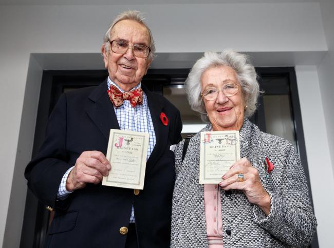 Henry and Ingrid Wuga with their 1939 Kindertransport passes Picture: Robert Perry.