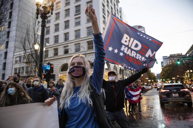 People flooded the streets to celebrate President-elect Joe Biden's win over President Donald Trump on Saturday in Portland, Ore. (AP Photo/Paula Bronstein).