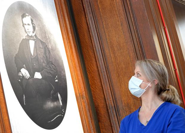HeraldScotland: Dt Kate Stevens with a portrait of Lister at Glasgow Royal Infirmary