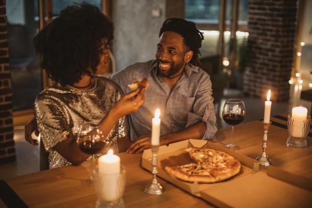 HeraldScotland: Young couple having romantic dinner at home
