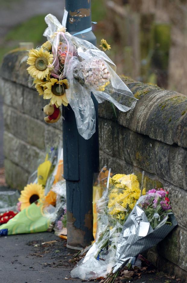 HeraldScotland: Flowers at the top of Dalkeith's Roan's Dyke path where Jodi Jones was murdered. 