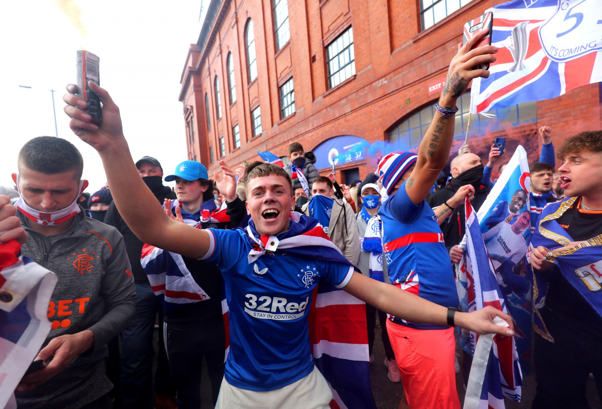 Rangers fans celebrate outside of the Ibrox Stadium after Rangers win the Scottish Premiership title. Picture date: Sunday March 7, 2021. PA Photo. See PA story SOCCER Rangers. Photo credit should read: Jane Barlow/PA Wire. 