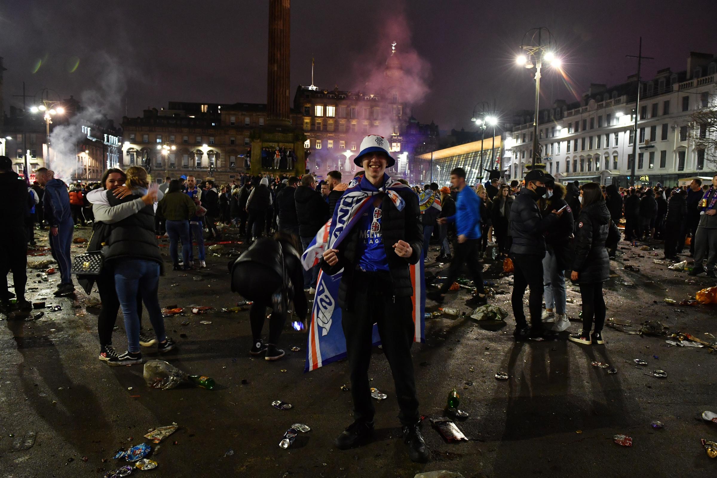 GLASGOW, SCOTLAND - MARCH 07: A fan cheers inside George Square as fans gather to celebrate their team winning the Scottish Premiership title on March 07, 2021 in Glasgow, Scotland. (Photo by Mark Runnacles/Getty Images).
