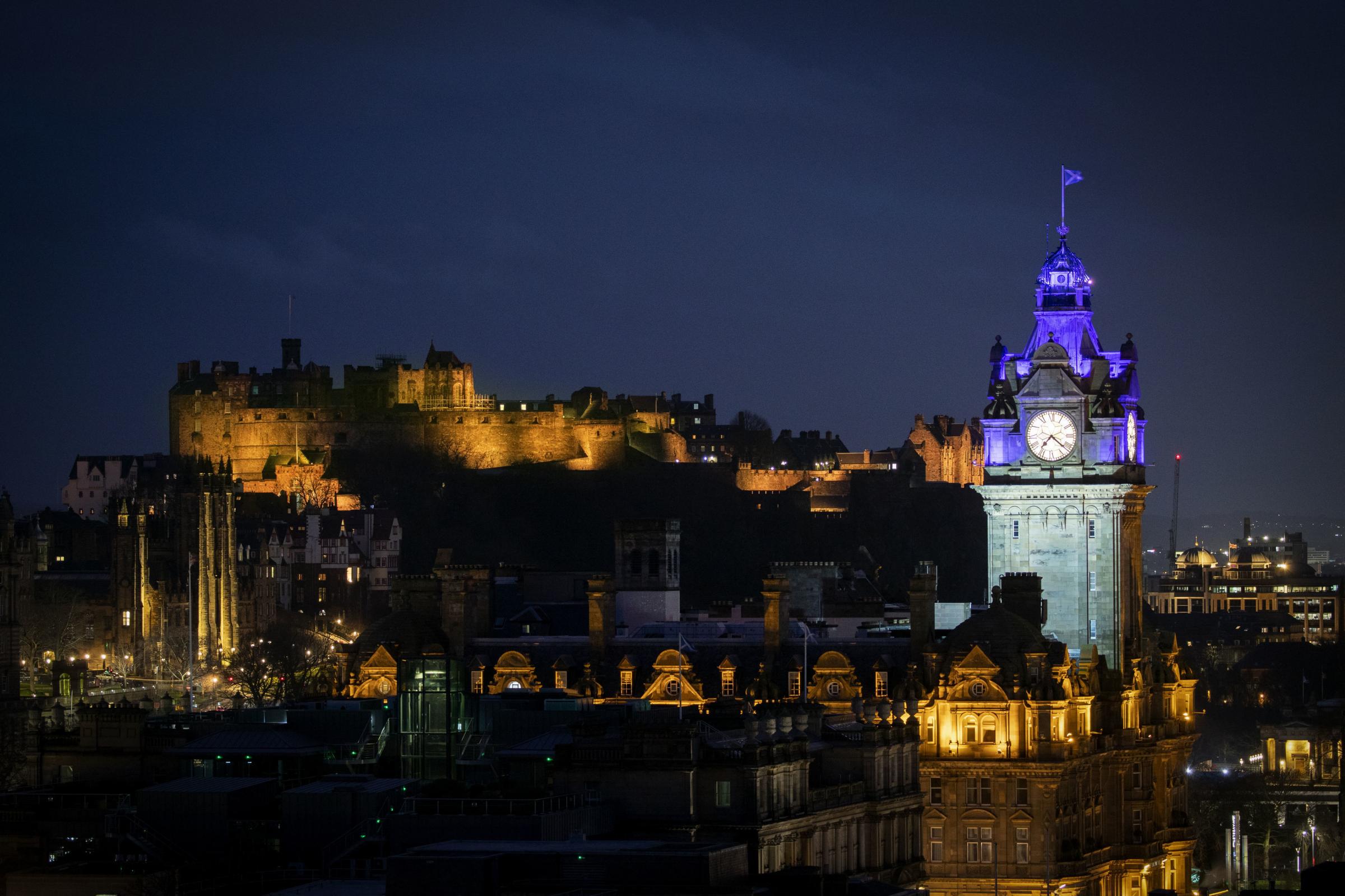 Edinburgh Castle is illuminated yellow during the National Day of Reflection, on the anniversary of the first national lockdown. Photo by Jane Barlow/PA Wire.