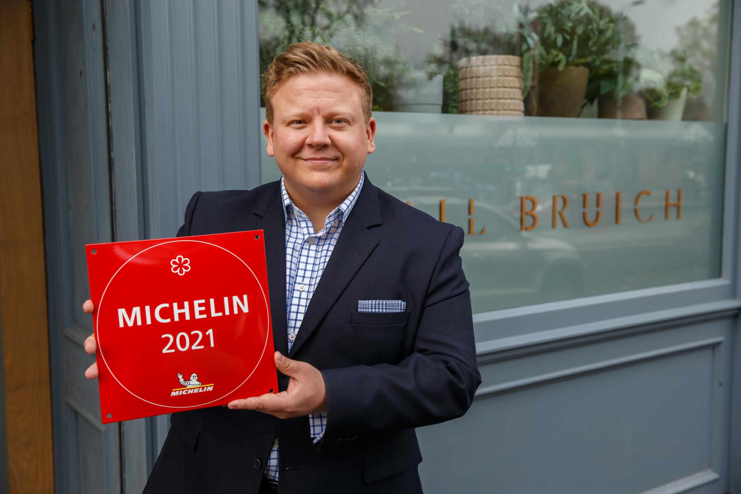Cail Bruich general manager Chris Donnachie holding the Michelin star plaque that the restaurant received recently. Photograph by Colin Mearns.